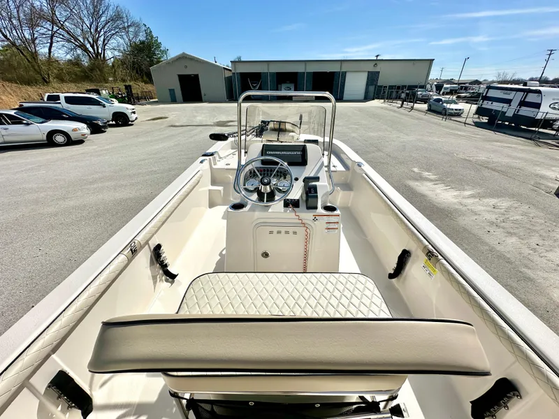 Slide: The Image of 2021 Carolina Skiff 21 LS boat interior with steering console in a parking lot. - 13