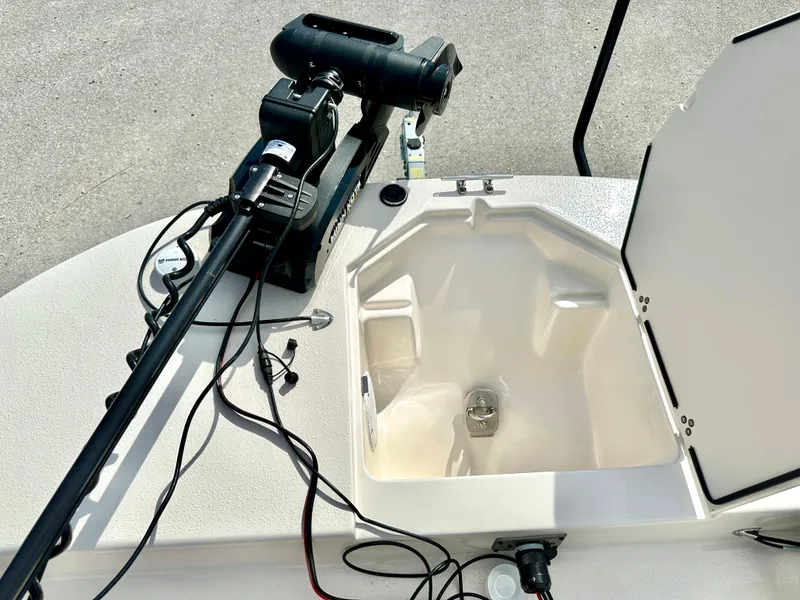 Slide: The Image of 2021 Carolina Skiff 21 LS boat with open storage compartment and mounted equipment. - 17