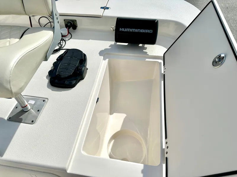 Slide: The Image of 2021 Carolina Skiff 21 LS boat interior with storage compartment and Humminbird device. - 20