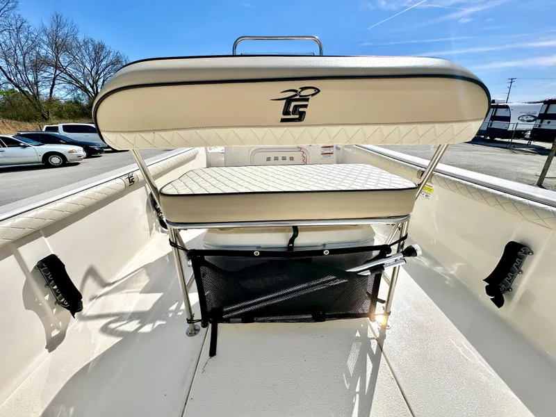 Slide: The Image of 2021 Carolina Skiff 21 LS boat interior with cushioned seating and storage. - 21
