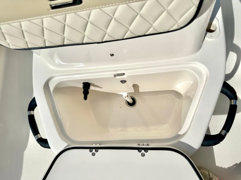 Slide: The Image of 2021 Carolina Skiff 21 LS boat storage compartment with quilted lid and handles. - 23