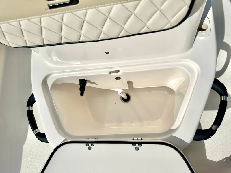 Slide: The Image of 2021 Carolina Skiff 21 LS boat storage compartment with quilted interior design. - 24