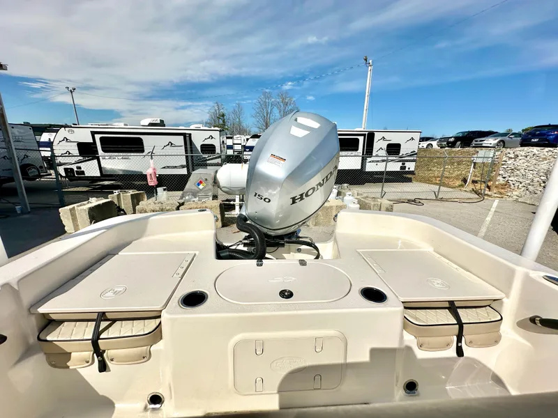 Slide: The Image of 2021 Carolina Skiff 21 LS boat with Honda 150 engine, parked near RVs. - 25