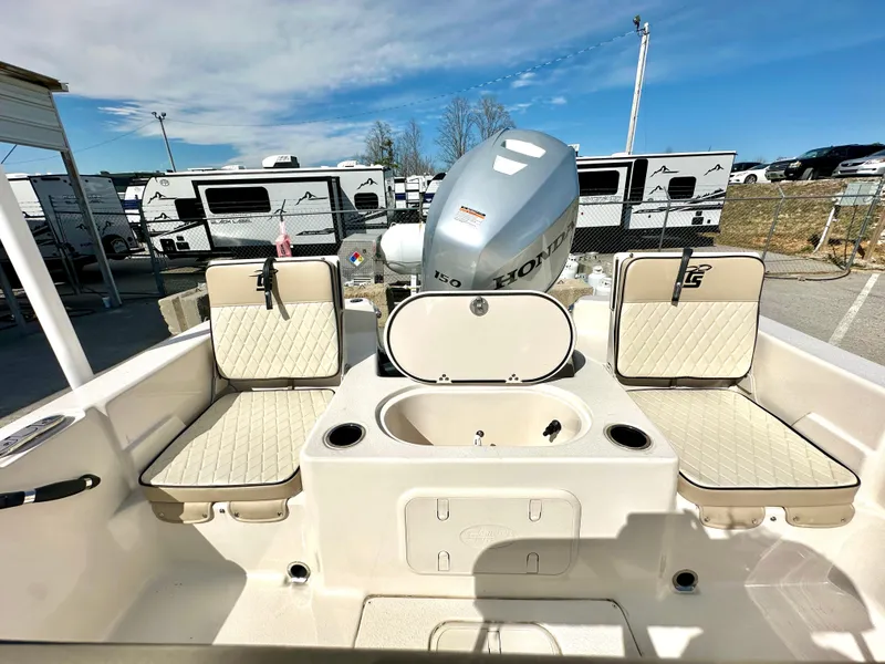 Slide: The Image of 2021 Carolina Skiff 21 LS boat interior with Honda engine, featuring seating and storage. - 26