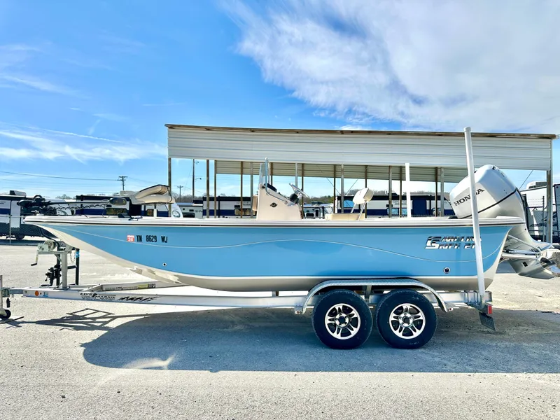 Slide: The Image of 2021 Carolina Skiff 21 LS boat on trailer, light blue hull, parked outdoors. - 3