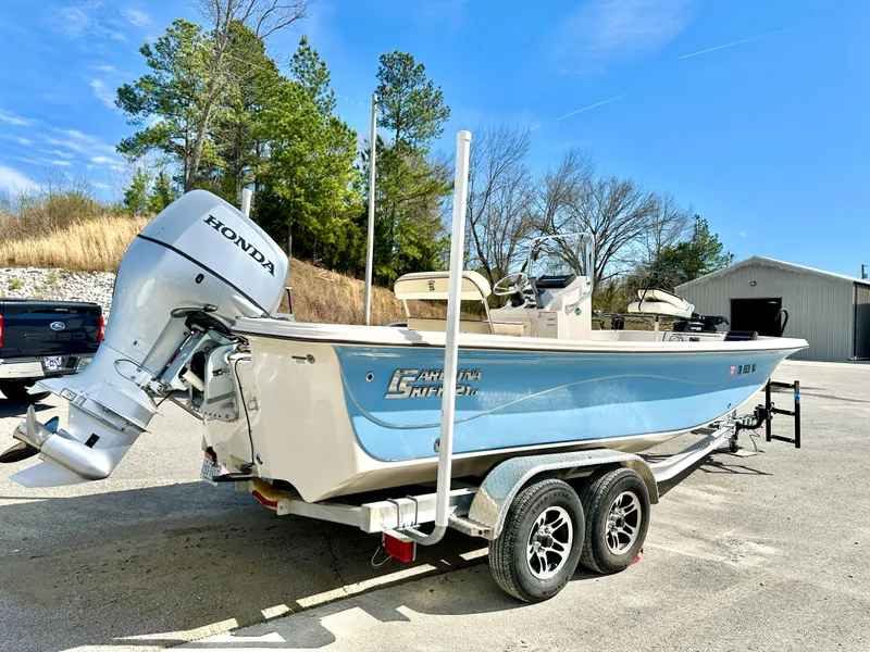 Slide: The Image of 2021 Carolina Skiff 21 LS boat with Honda outboard motor on a trailer. - 5