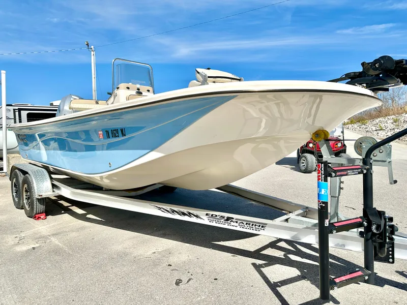 Slide: The Image of 2021 Carolina Skiff 21 LS boat on trailer, blue and white design, sunny day. - 7