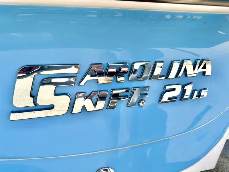 Slide: The Image of 2021 Carolina Skiff 21 LS logo on blue boat exterior. - 8