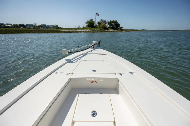 Slide: The Image of Bow view of 2023 Pathfinder 2300 HPS boat on calm water with clear sky. - 10