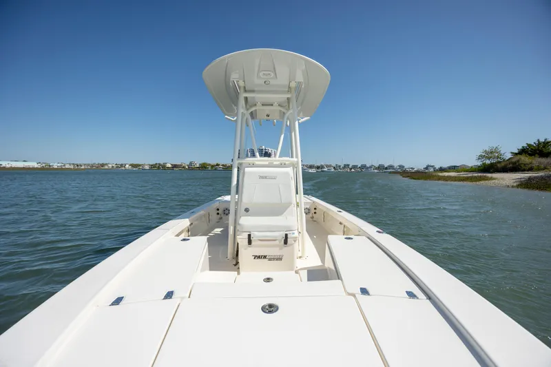 Slide: The Image of 2023 Pathfinder 2300 HPS boat on water, clear sky, coastal background. - 14