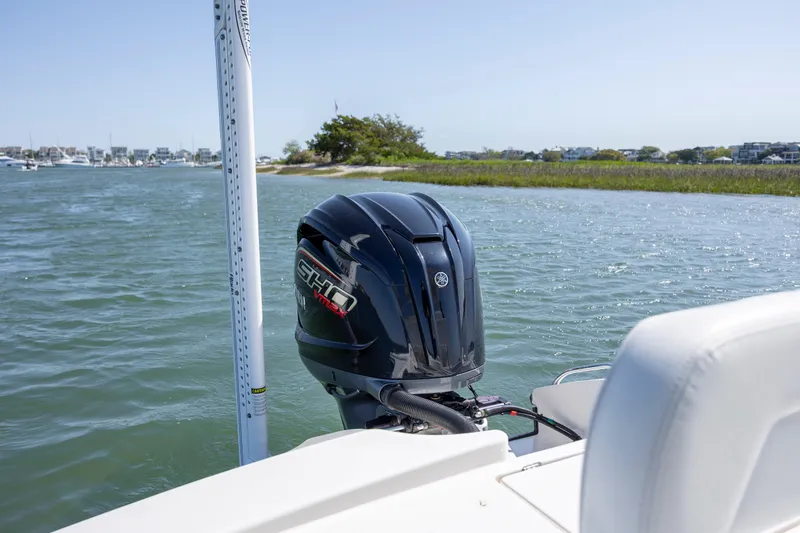 Slide: The Image of 2023 Pathfinder 2300 HPS boat with Yamaha outboard motor on a calm waterway. - 21