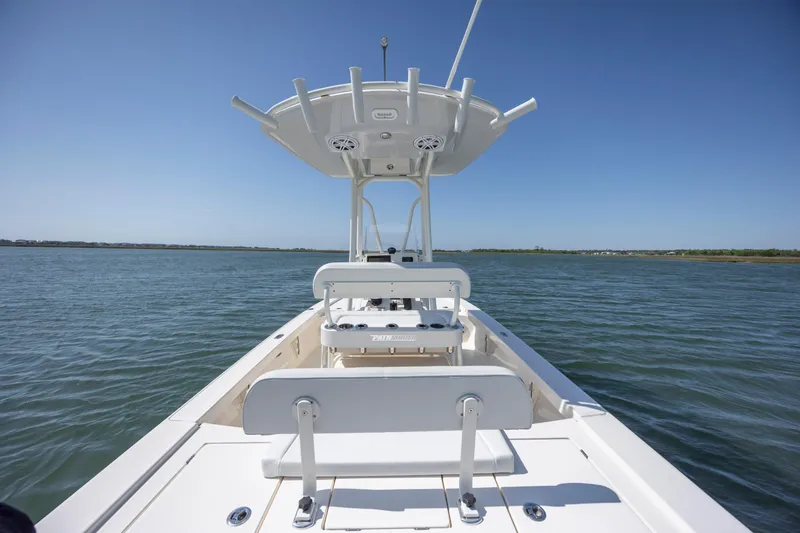 Slide: The Image of 2023 Pathfinder 2300 HPS boat on calm water under clear blue sky. - 22