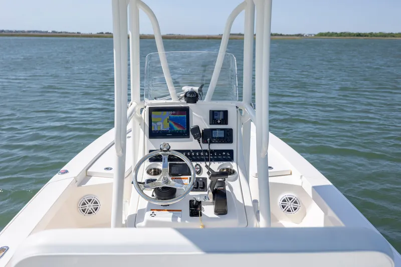 Slide: The Image of 2023 Pathfinder 2300 HPS boat console with navigation equipment on open water. - 24