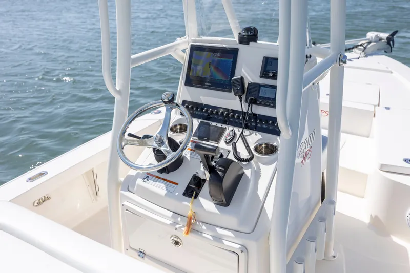 Slide: The Image of 2023 Pathfinder 2300 HPS boat console with steering wheel and navigation equipment. - 26
