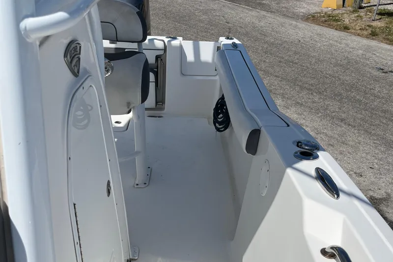 Slide: The Image of 2018 Tidewater 232 CC Adventure boat interior, featuring seating and storage areas. - 12