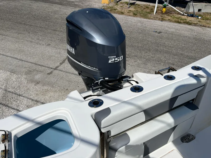 Slide: The Image of 2018 Tidewater 232 CC Adventure boat with Yamaha 250 engine, docked on pavement. - 6