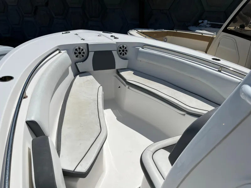 Slide: The Image of 2018 Tidewater 232 CC Adventure boat interior with cushioned seating and speakers. - 7