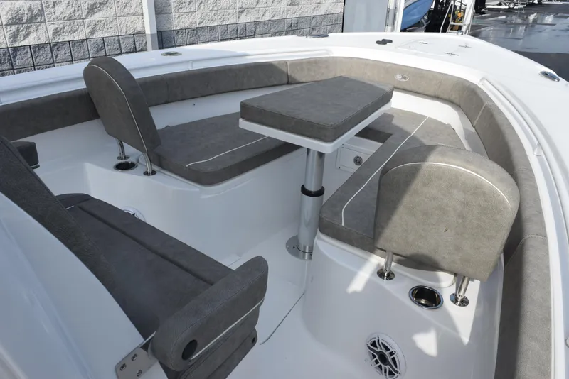 Slide: The Image of 2025 Sea Hunt Ultra 305 SE boat interior with cushioned seating and table. - 11