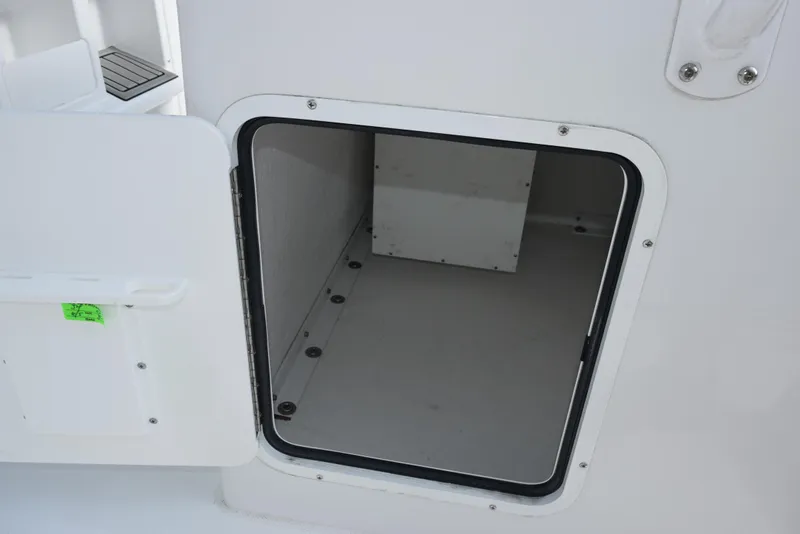 Slide: The Image of Open storage compartment on 2025 Sea Hunt Ultra 305 SE boat. - 16