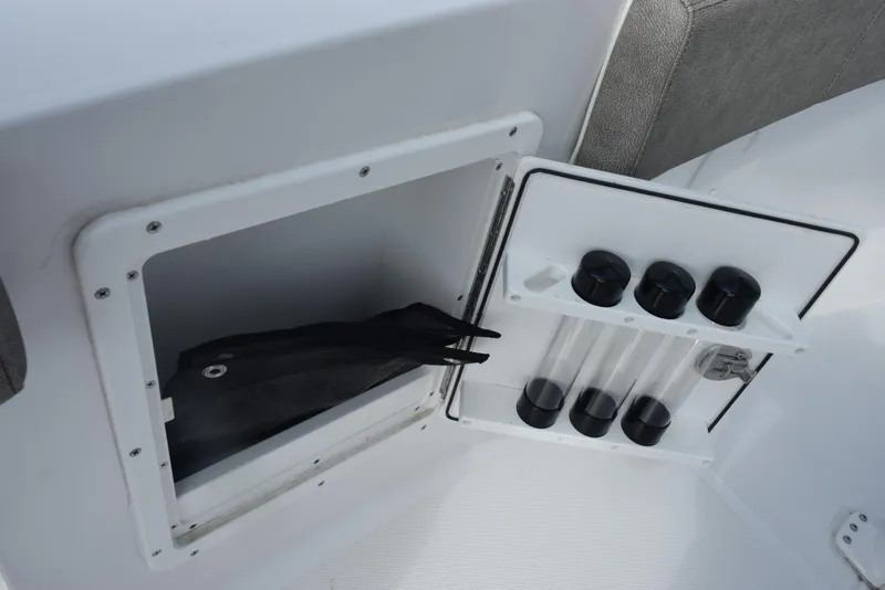 Slide: The Image of Storage compartment on 2025 Sea Hunt Ultra 305 SE boat with fishing rod holders. - 17