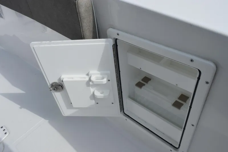 Slide: The Image of Open storage compartment on 2025 Sea Hunt Ultra 305 SE boat. - 18