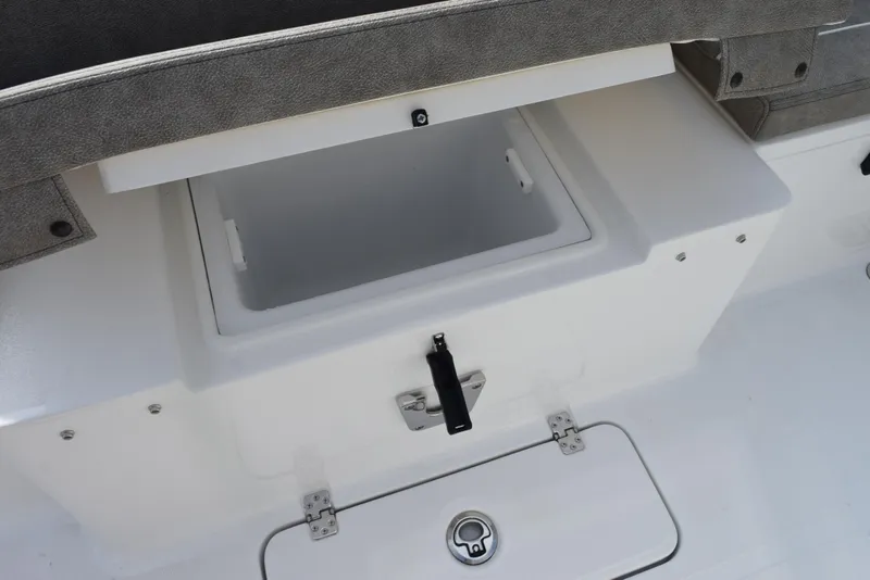 Slide: The Image of 2025 Sea Hunt Ultra 305 SE boat storage compartment, open lid, white interior. - 19