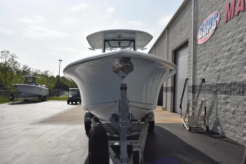 Slide: The Image of 2025 Sea Hunt Ultra 305 SE boat on trailer outside a marine dealership. - 3