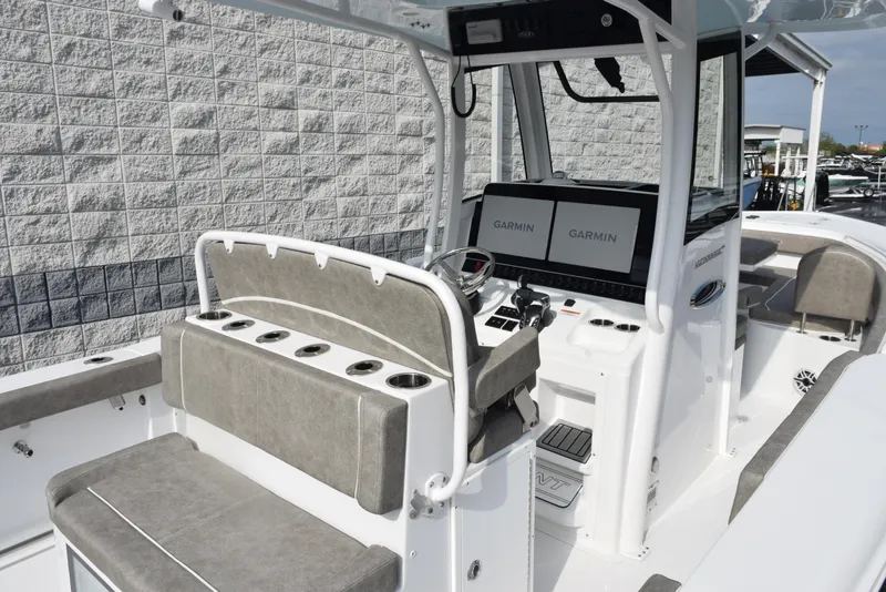 Slide: The Image of 2025 Sea Hunt Ultra 305 SE boat interior with dual Garmin displays and cushioned seating. - 7