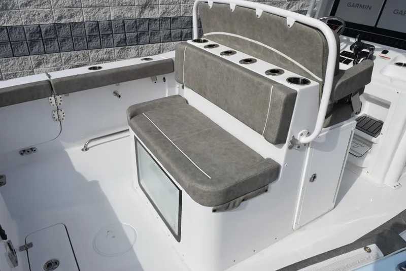 Slide: The Image of 2025 Sea Hunt Ultra 305 SE boat interior with cushioned seating and storage. - 8