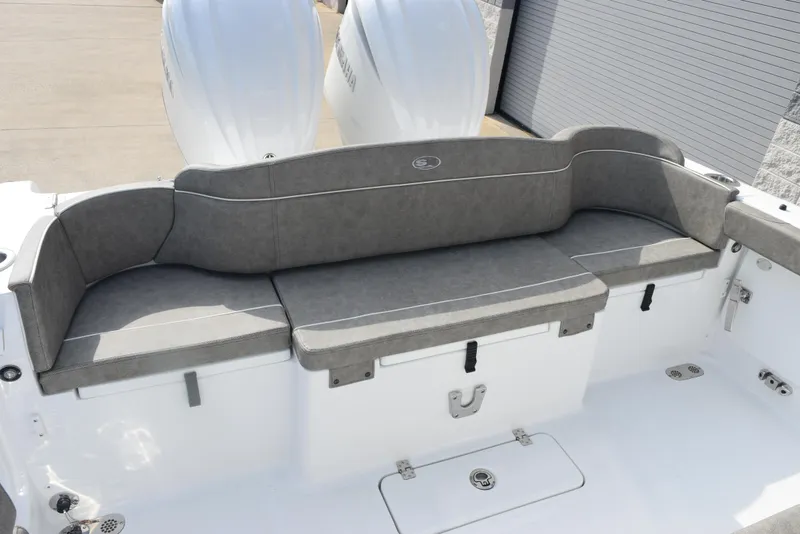 Slide: The Image of 2025 Sea Hunt Ultra 305 SE boat with cushioned seating and dual engines. - 9