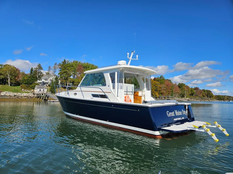 Slide: The Image of 2008 Back Cove 33 Express boat on calm water under a clear blue sky. - 0
