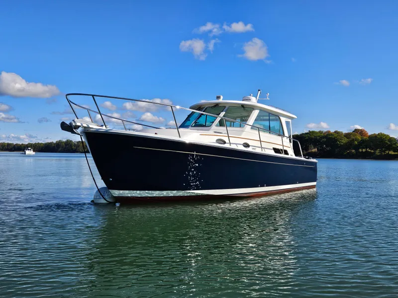 Slide: The Image of 2008 Back Cove 33 Express boat on calm water under a clear blue sky. - 1