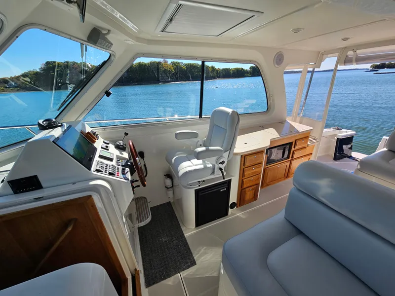 Slide: The Image of Interior of 2008 Back Cove 33 Express yacht with helm, seating, and scenic water view. - 18