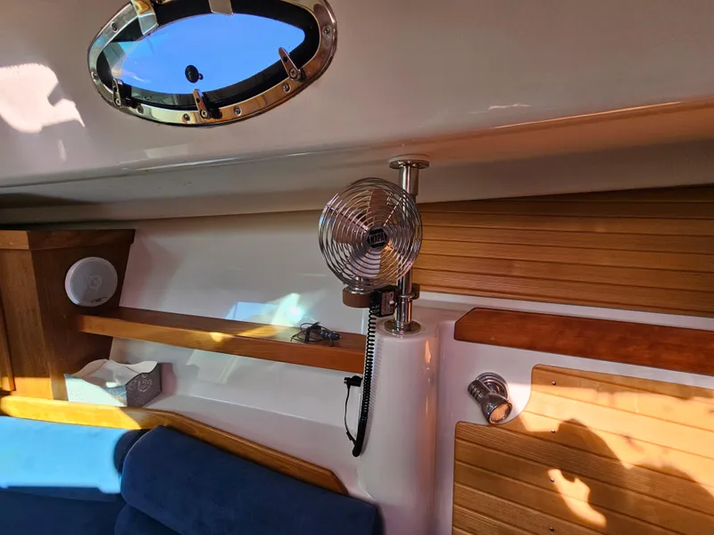 Slide: The Image of Interior of 2008 Back Cove 33 Express with wood paneling and blue seating. - 28