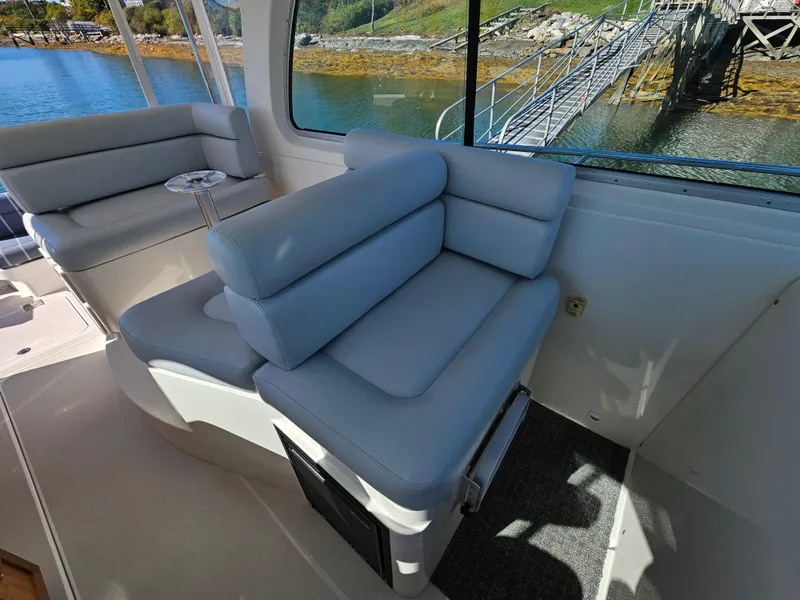 Slide: The Image of Interior seating of 2008 Back Cove 33 Express boat with waterfront view. - 29