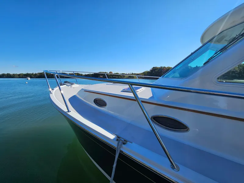 Slide: The Image of 2008 Back Cove 33 Express boat on calm water under clear blue sky. - 34