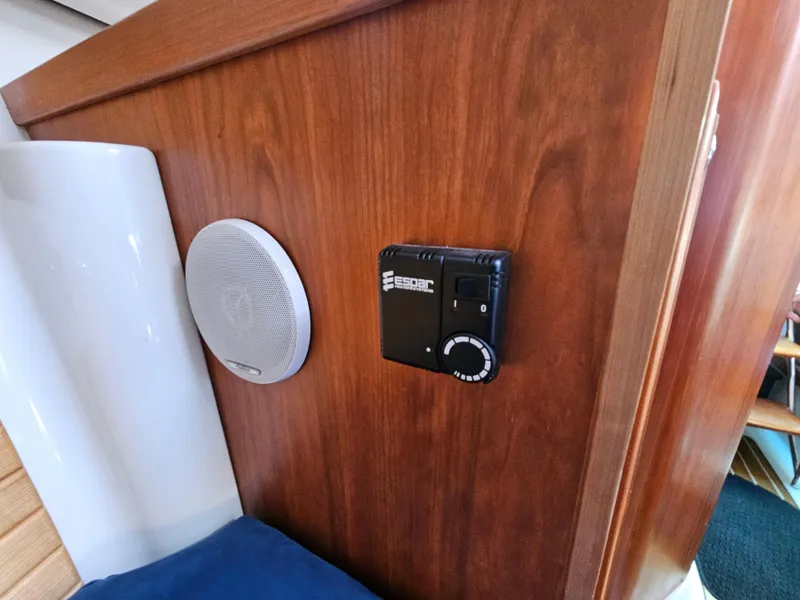 Slide: The Image of 2008 Back Cove 33 Express interior with speaker and control panel on wooden wall. - 49