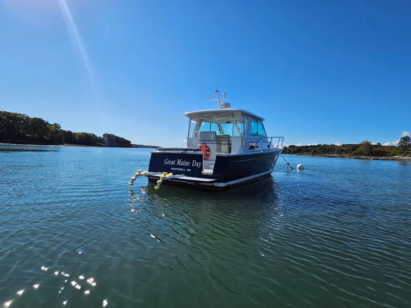 Slide: The Image of 2008 Back Cove 33 Express boat on calm water under clear blue sky. - 6