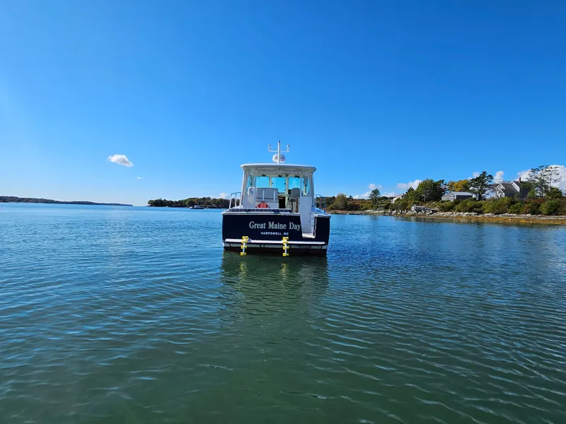 Slide: The Image of 2008 Back Cove 33 Express boat on calm water under clear blue sky. - 7