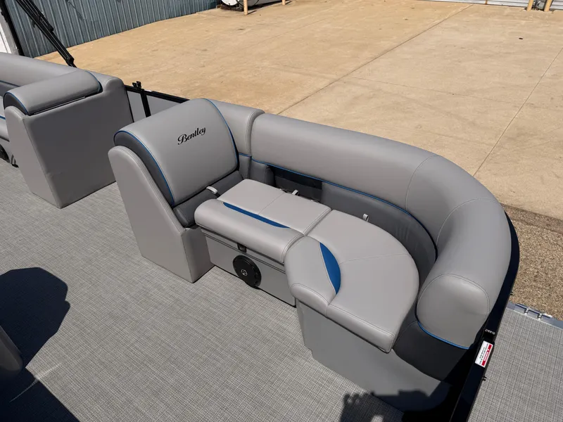 Slide: The Image of 2025 Bentley Pontoons Bolt 223 interior with gray seating and blue accents. - 10