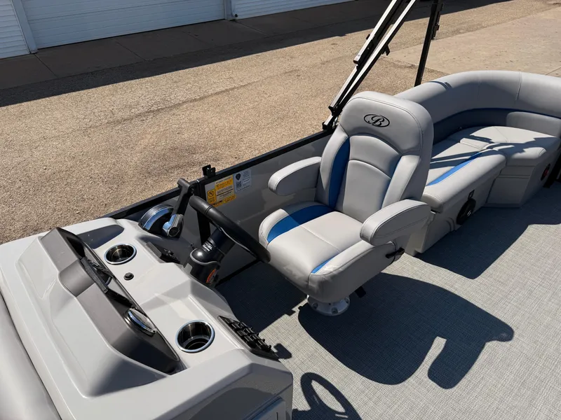 Slide: The Image of 2025 Bentley Pontoons Bolt 223 interior with modern helm and comfortable seating. - 12