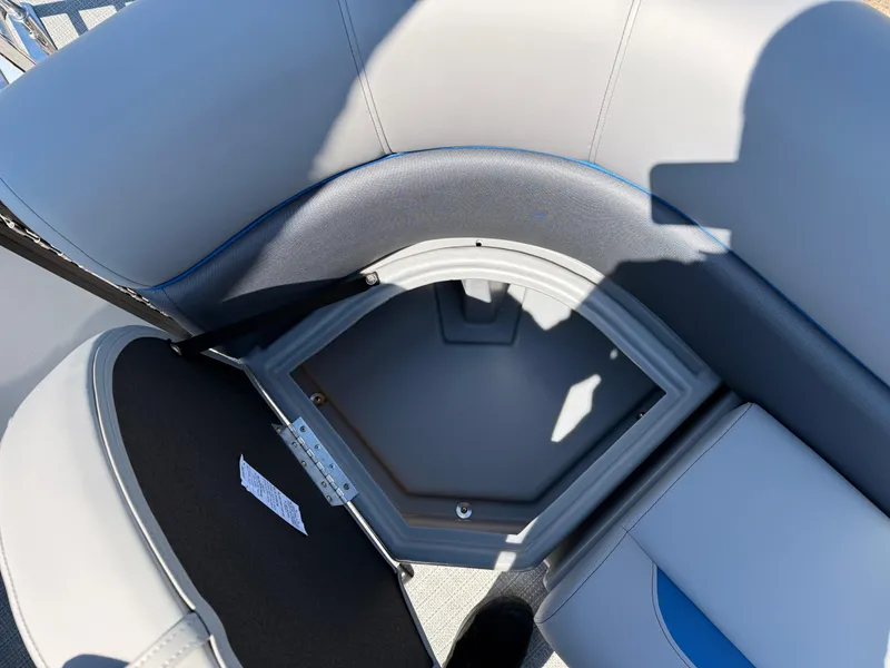 Slide: The Image of 2025 Bentley Pontoons Bolt 223 storage compartment with cushioned seating and open hatch. - 23
