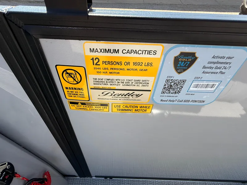 Slide: The Image of Bentley Pontoons Bolt 223, 2025 model, capacity label for 12 people or 1692 lbs. - 26