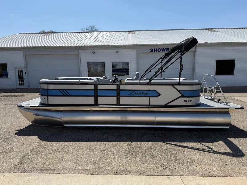 Slide: The Image of 2025 Bentley Pontoons Bolt 223 pontoon boat parked outside a showroom. - 4