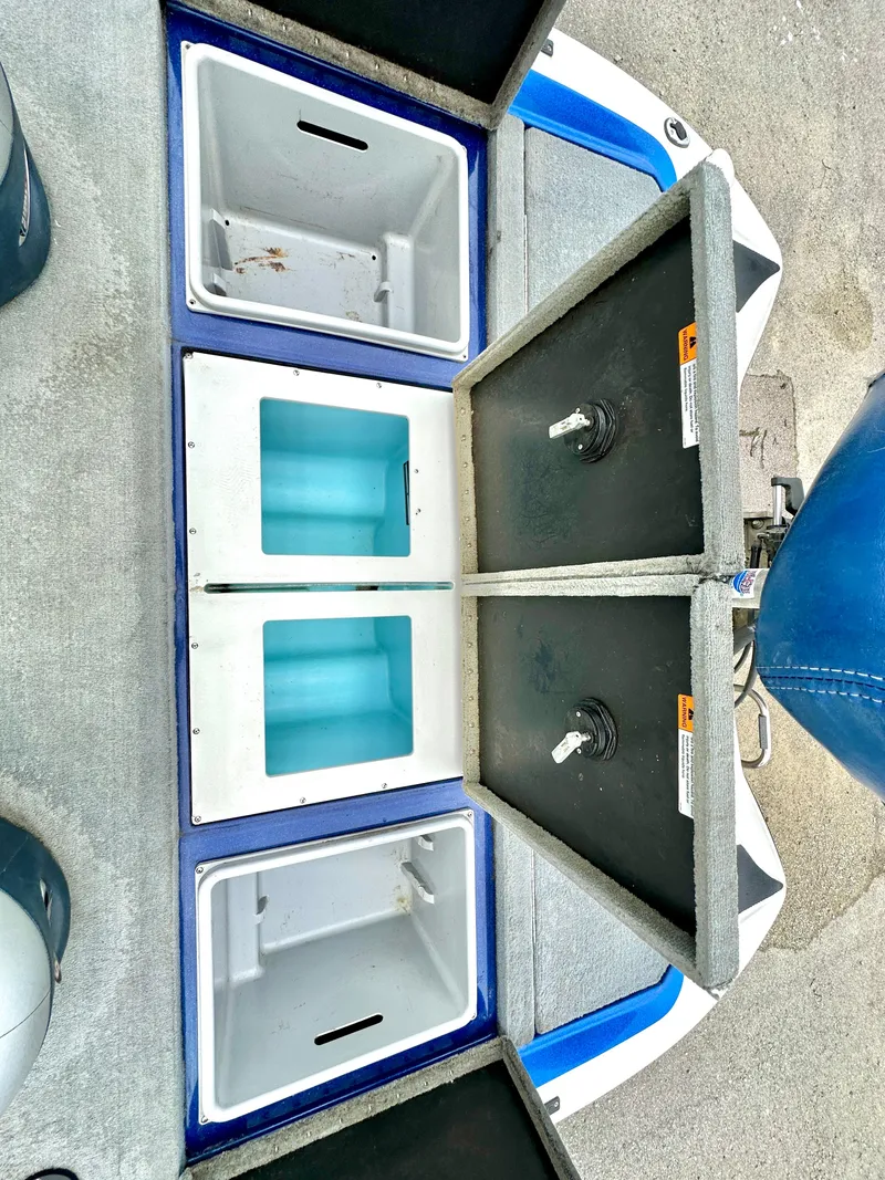 Slide: The Image of 2009 Stratos 294 XL Evolution boat storage compartments open, showing interior layout. - 10