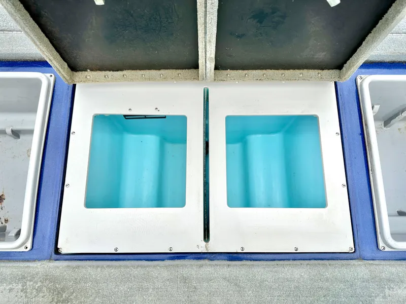 Slide: The Image of Livewell compartments on a 2009 Stratos 294 XL Evolution boat, featuring open lids. - 11