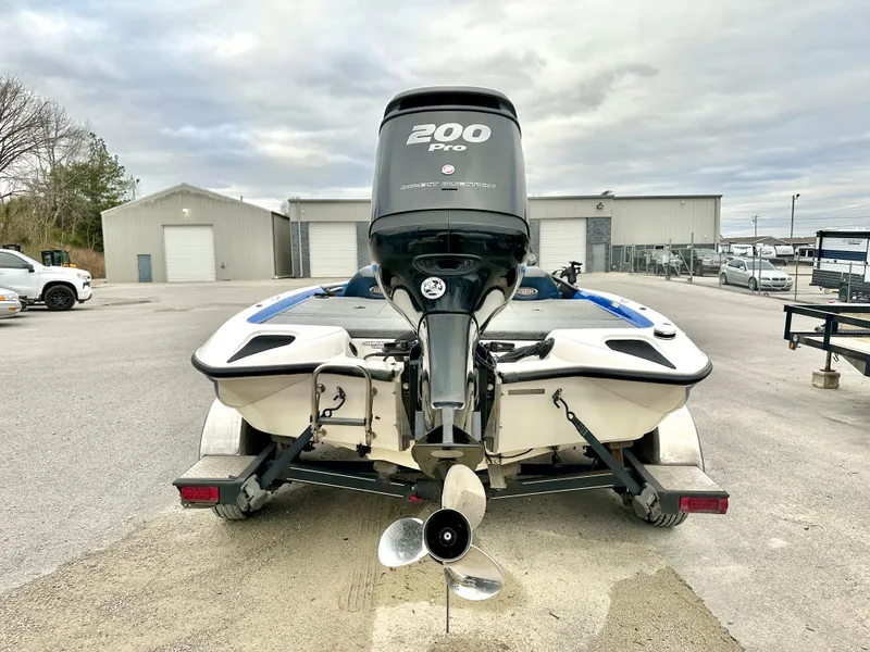 Slide: The Image of 2009 Stratos 294 XL Evolution boat with 200 Pro motor, rear view in a parking lot. - 3