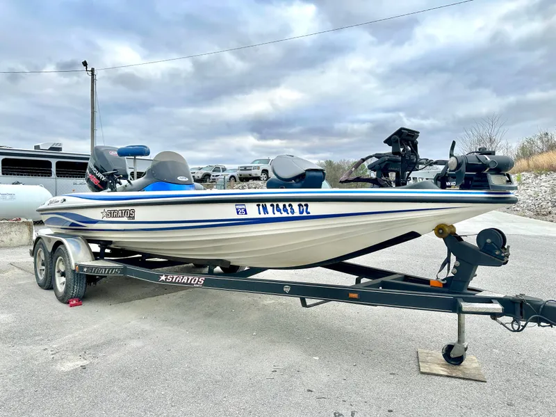 Slide: The Image of 2009 Stratos 294 XL Evolution boat on trailer, parked outdoors under cloudy sky. - 6