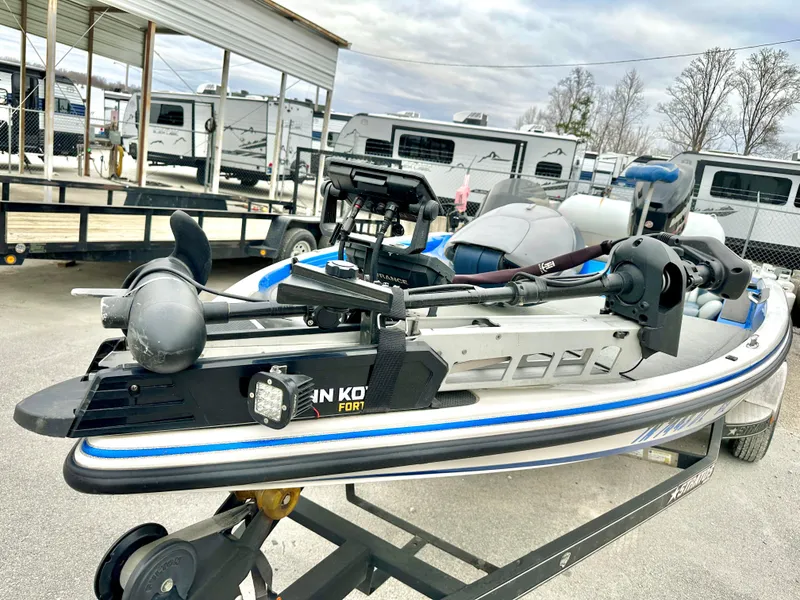 Slide: The Image of 2009 Stratos 294 XL Evolution boat on trailer, featuring a Minn Kota trolling motor. - 7