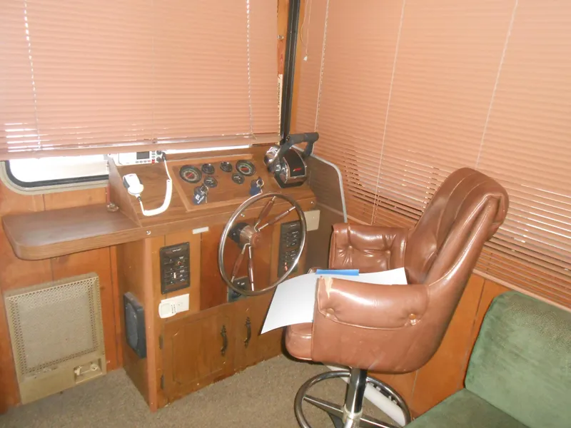 Slide: The Image of 1984 Boatel Hercules helm with vintage controls and brown leather captain's chair. - 14